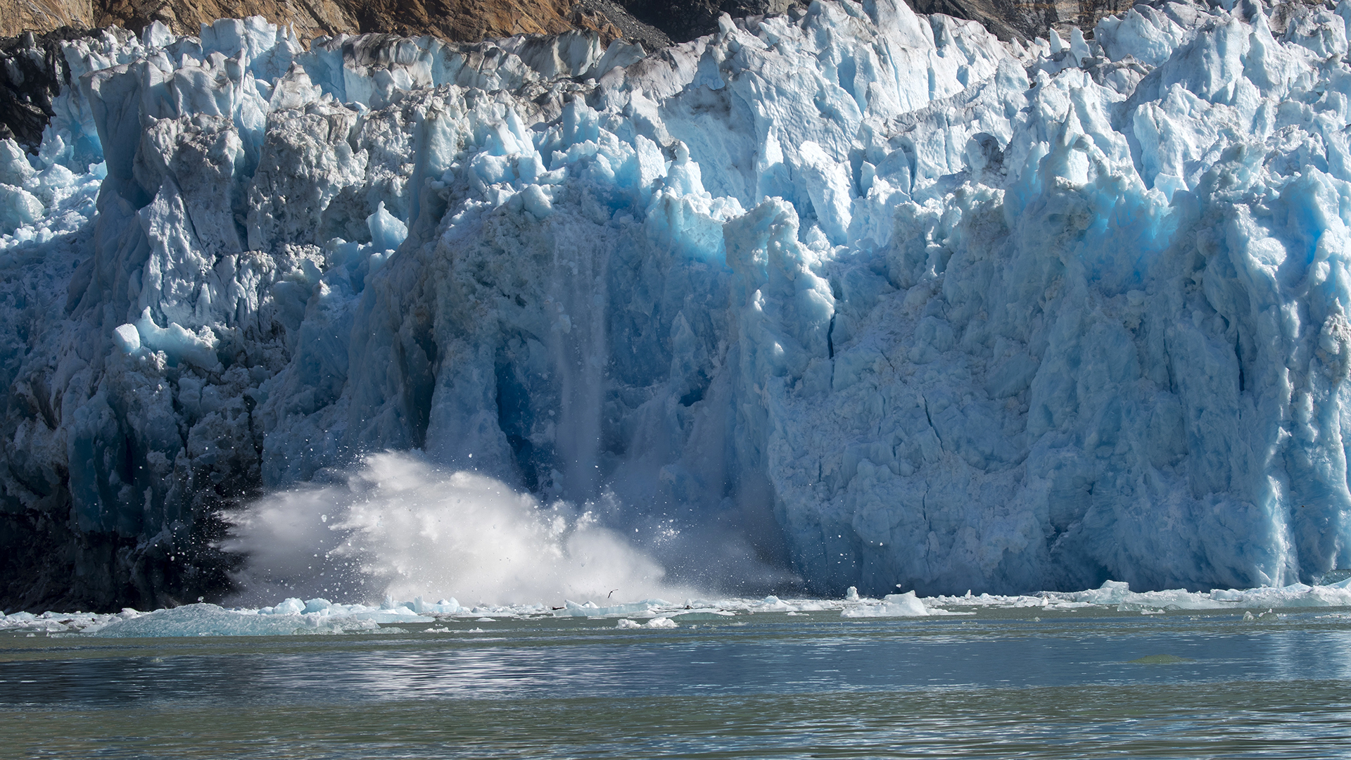 Chunks of ice are calving from the glacier face of the South